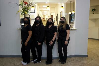 Glow Dental team standing by front desk